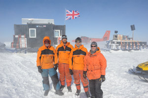 The iSTAR deployment team in front of the accommodation caboose, at the overwintering depot site with a Twin Otter in the background