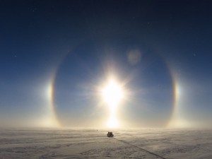 The DELORES (Deep-Looking Radio Echo Sounder) radar is towed in midnight sunshine with a halo and sun dogs. Photo: Jan De Rydt.