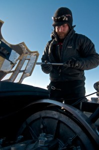 Deep Field Mechanic Mark Baird Services a field ski-doo. Photo: Alex Taylor