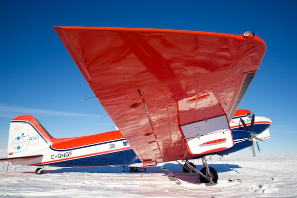 "Polar 6", The AWI Basler aircraft parked overnight at iSTAR Site 13, Pine Island Glacier. A white aerial radar sensor can be seen suspended under the wing. Photo: Alex Taylor.